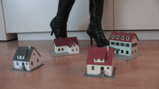 Model railway houses under sexy boots